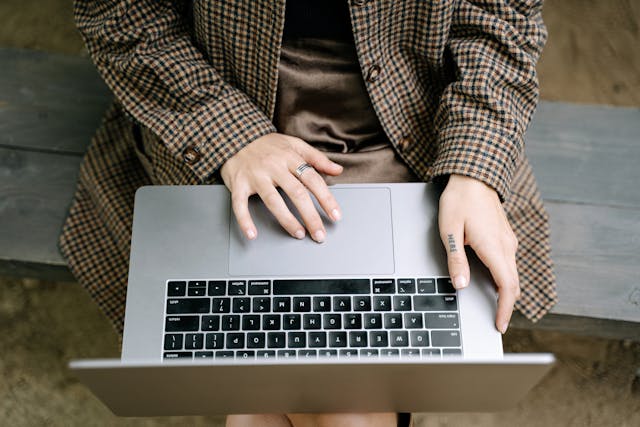 person-working-on-laptop-on-bench